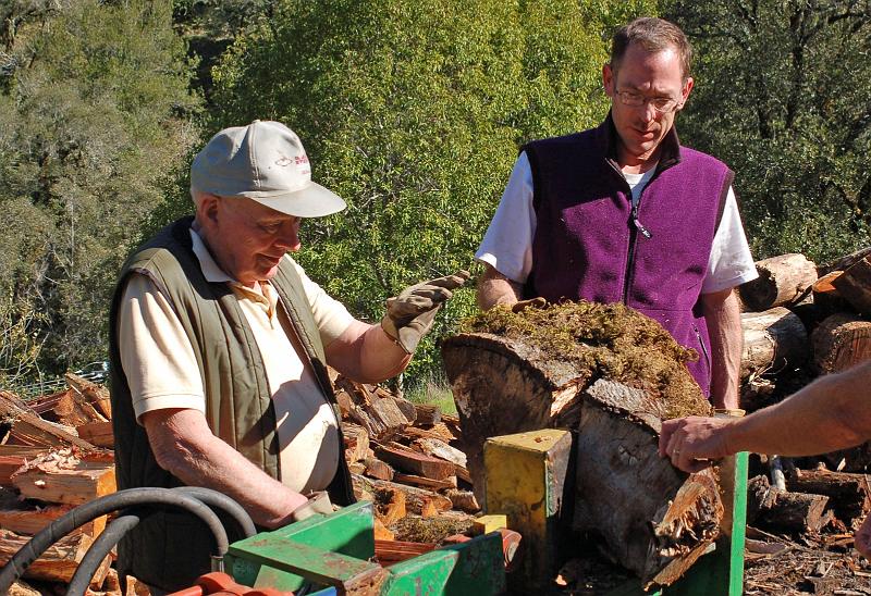Splitter In Action 1.jpg - We also employed a wood splitter to handle the most difficult pieces. Here Bruce Raby (left) and Steven Graham attend to the task.